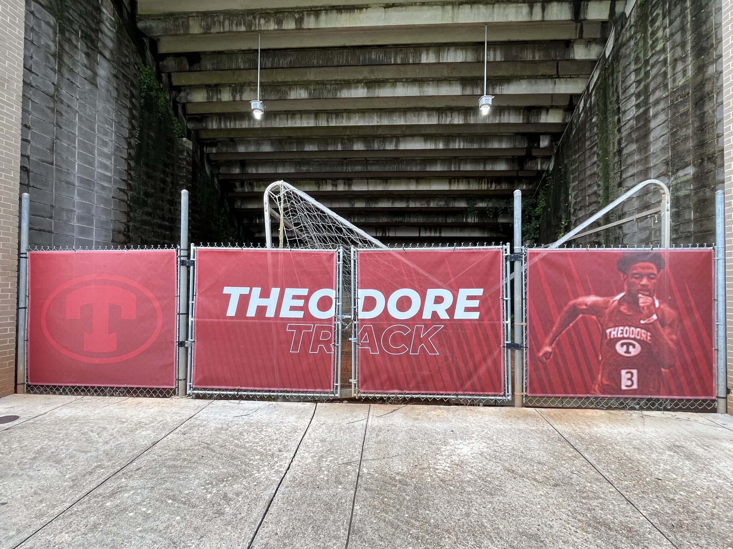 Custom vinyl bleacher bay banners installed under stadium bleachers at Theodore High School featuring Bobcat Nation graphics.