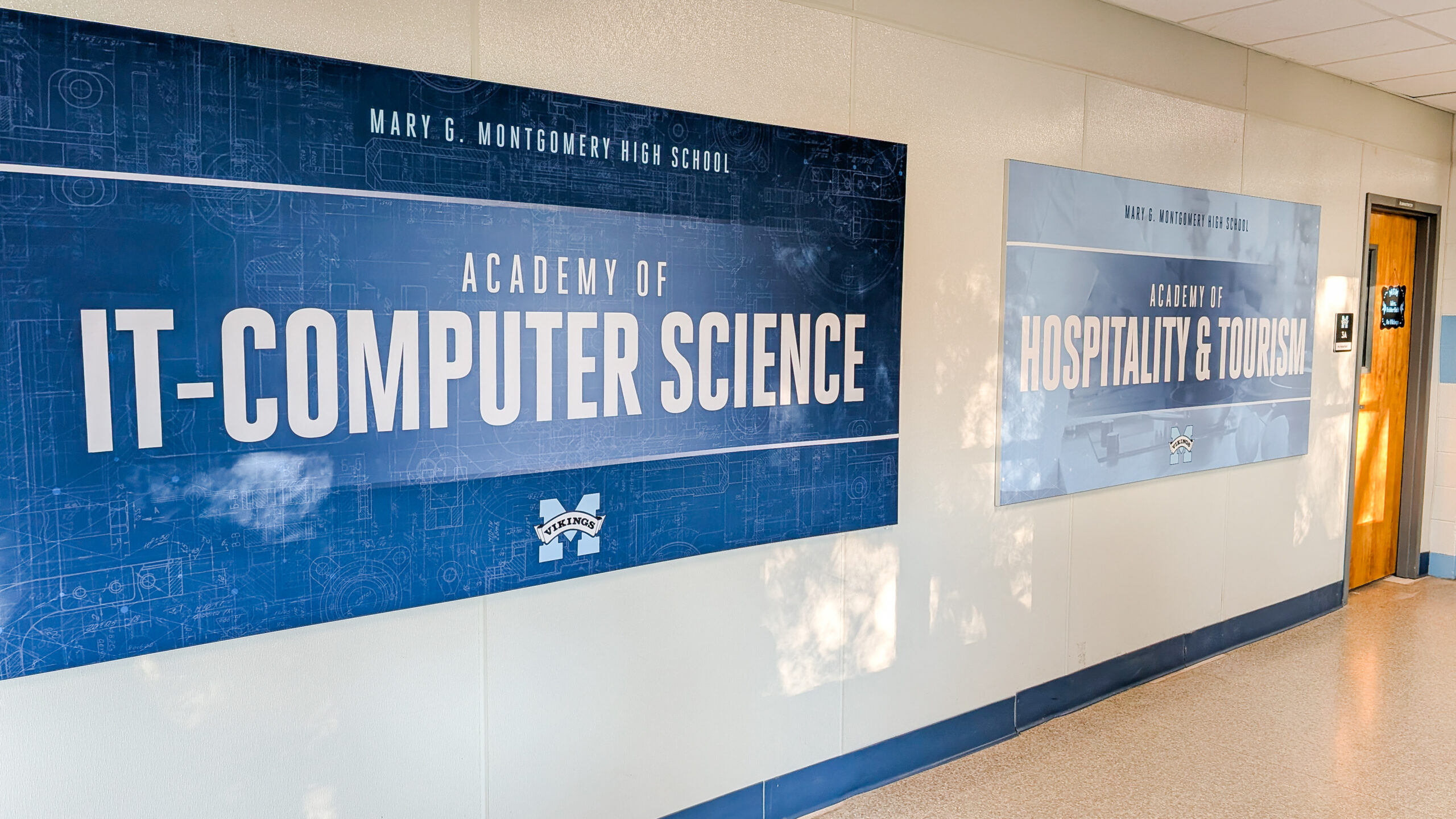 • Interior school branding featuring academy signage in aluminum SEG frames