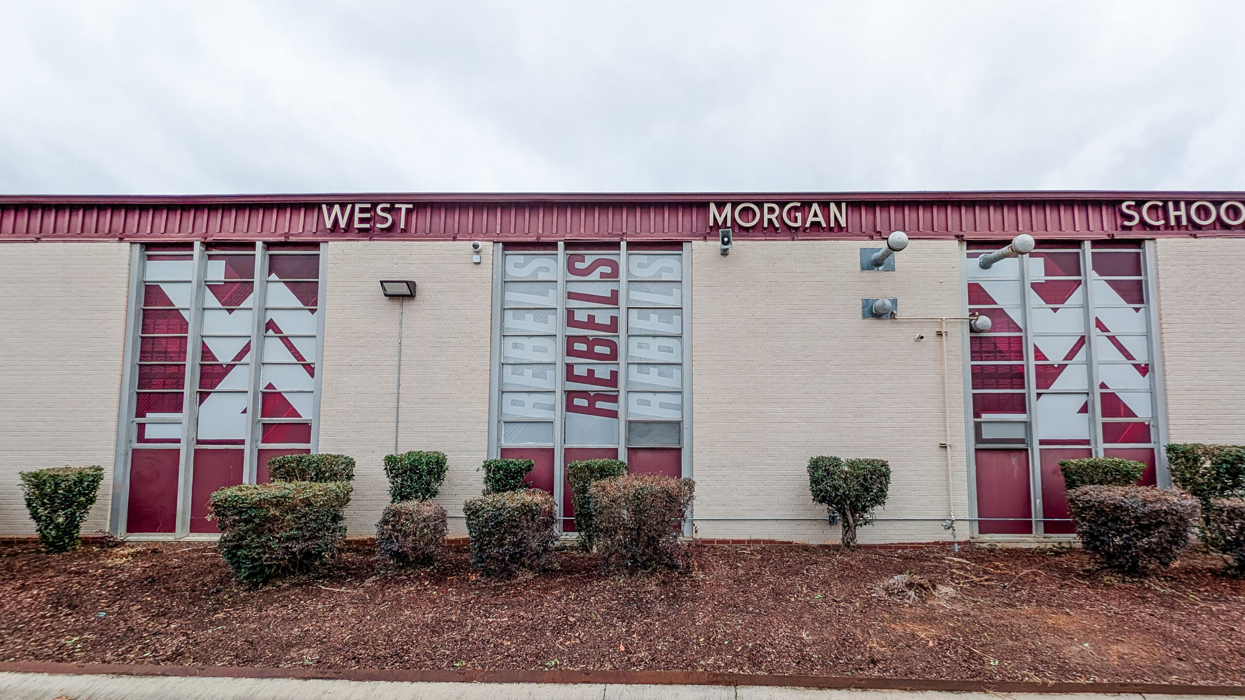 Exterior school windows with perforated vinyl graphics for branding and privacy