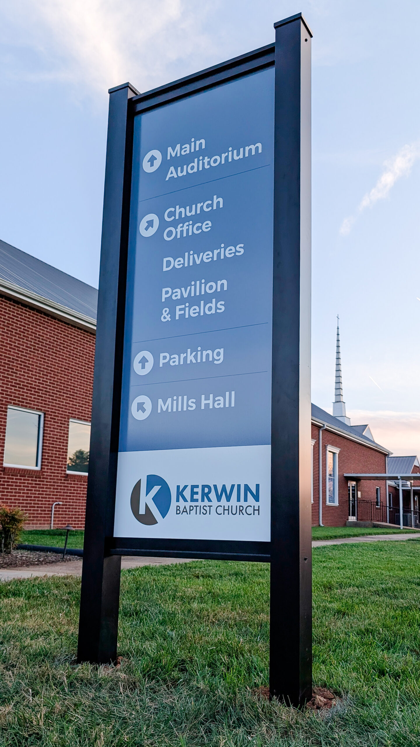 Outdoor directional signage at Kerwin Baptist Church in Kernersville, North Carolina, guiding visitors to the main auditorium, church office, parking, and Mills Hall.