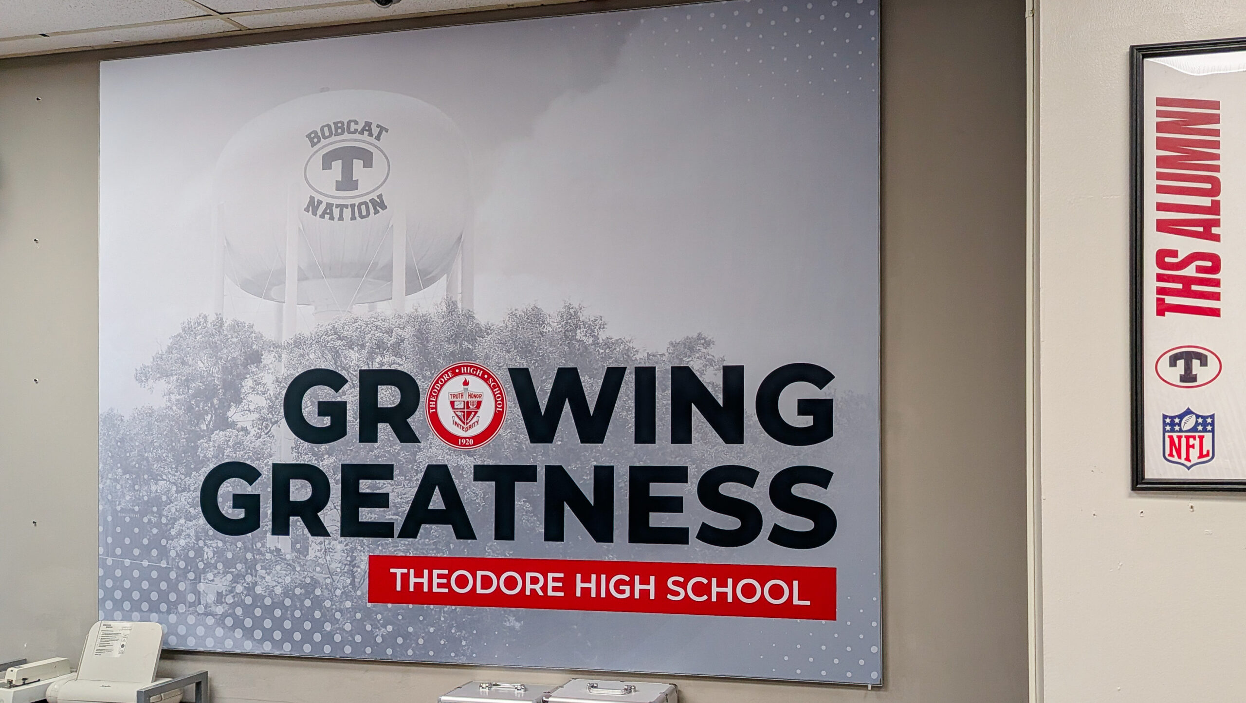 SEG fabric wall graphic installed in school main office with Theodore High School branding