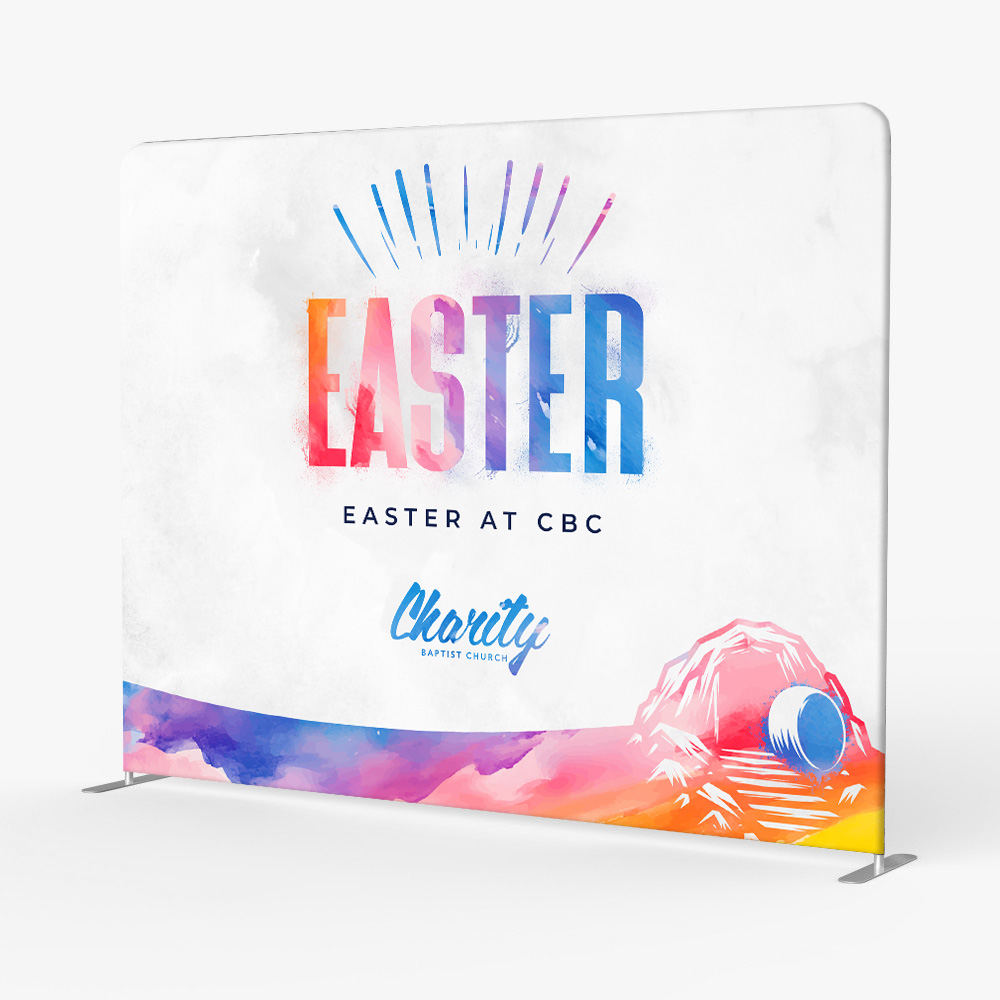 Custom Easter stage backdrop for Charity Baptist featuring colorful watercolor textures and modern Easter typography.