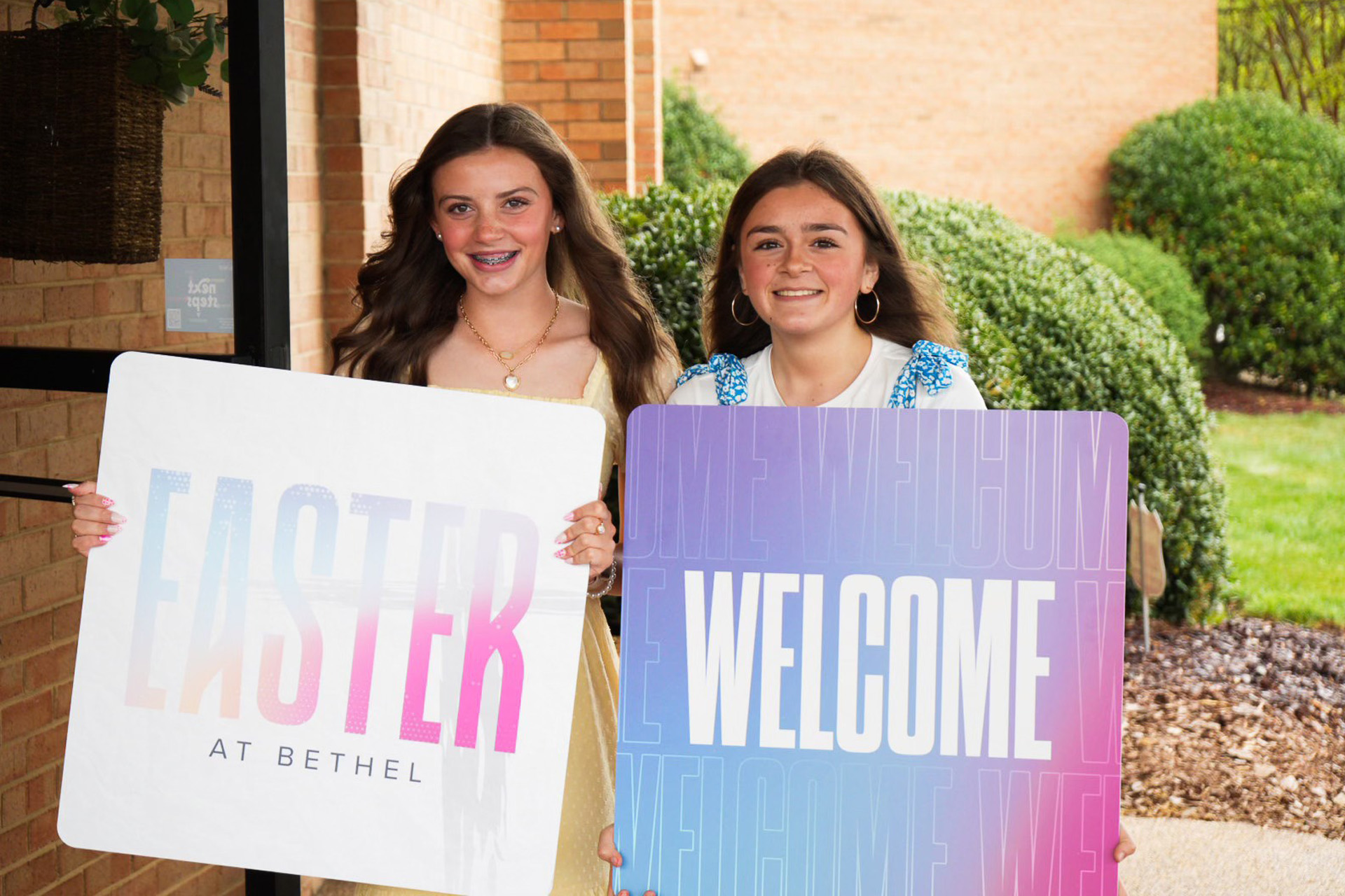 Custom handheld welcome signs used by church welcome team volunteers to greet guests.
