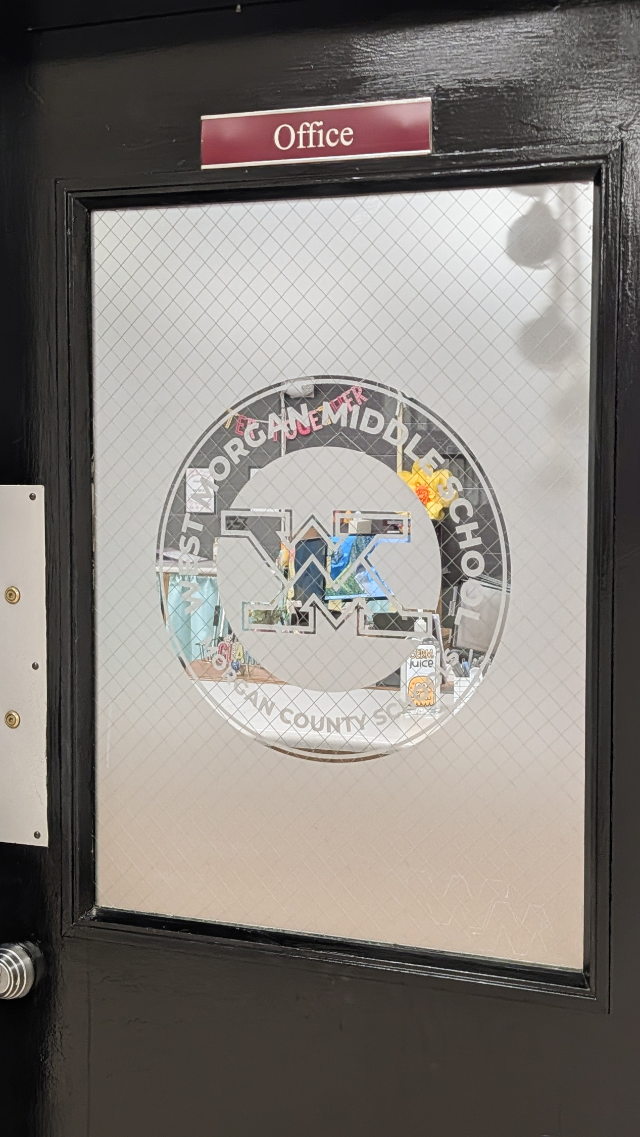 West Morgan Middle School Office Etched Glass Vinyl Etched glass vinyl featuring the West Morgan Middle School logo installed on an office door window in Trinity Alabama.