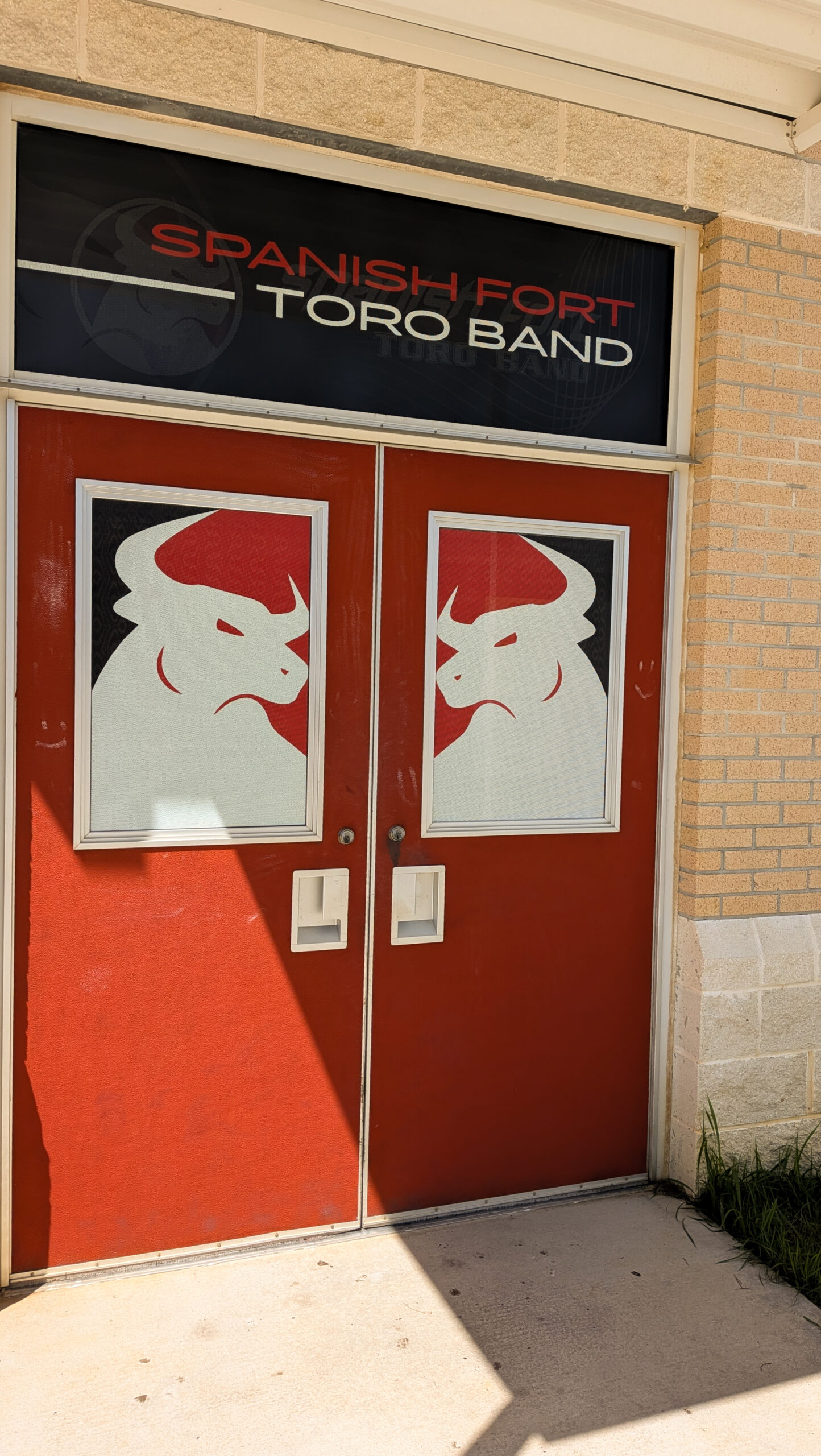 Spanish Fort High School Toro Band Door Graphics Custom window perf graphics featuring the Toro Band logo installed on the band room entrance doors at Spanish Fort High School in Alabama.